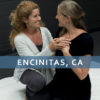 Icon for Phoenix Rising Essentials, showing two women facing each other, hands over one's heart