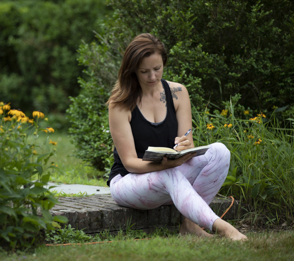 online yoga therapy training students practicing yoga therapy woman writing in journal